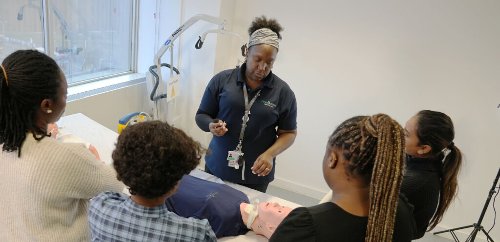 Staff member leading training session with other staff members