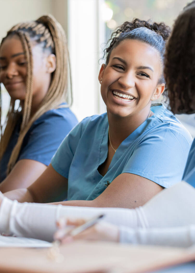 Smiling healthcare workers being training