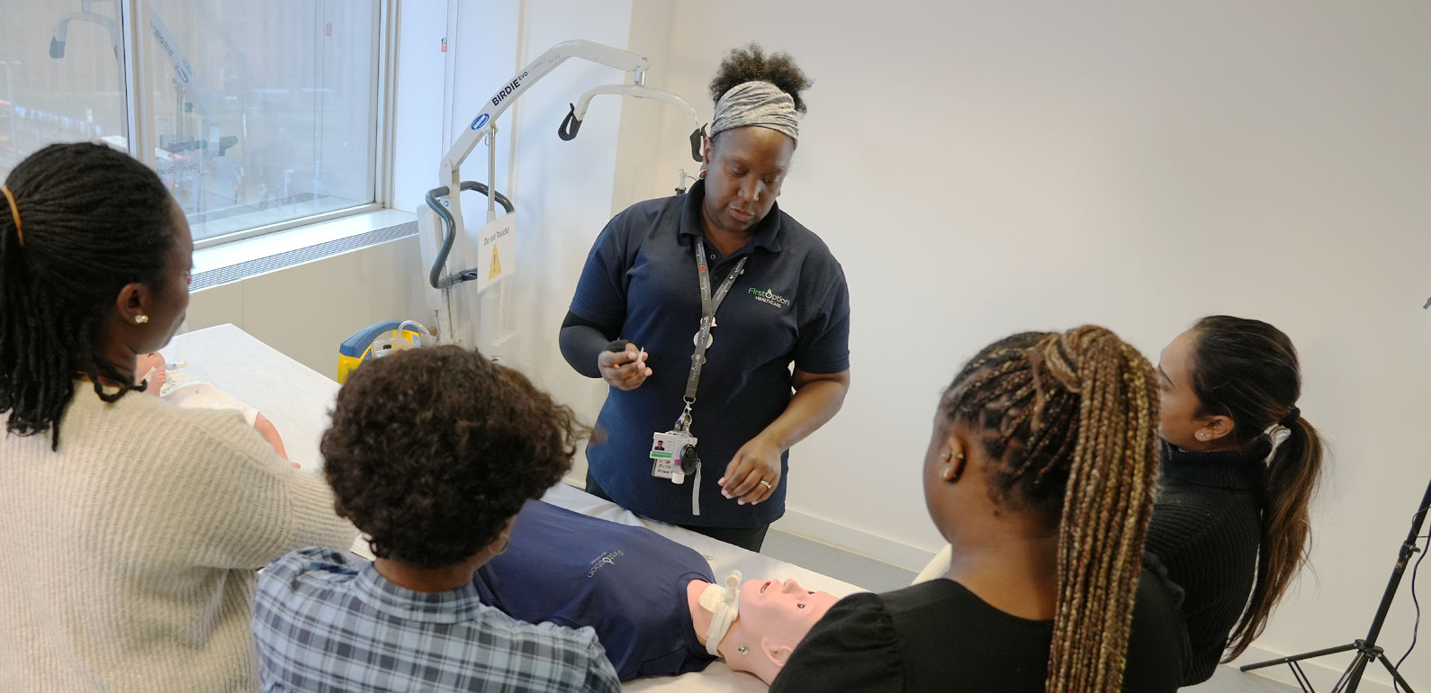 First Option staff member leading a training session with a group of trainees
