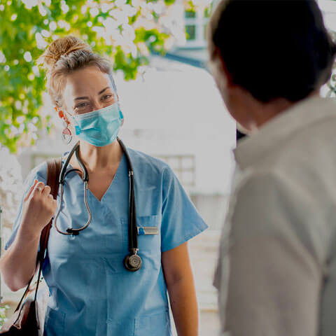 Health worker at front door and a person holding the door open