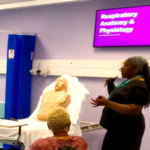 First Option staff member training others in First Option training facilities