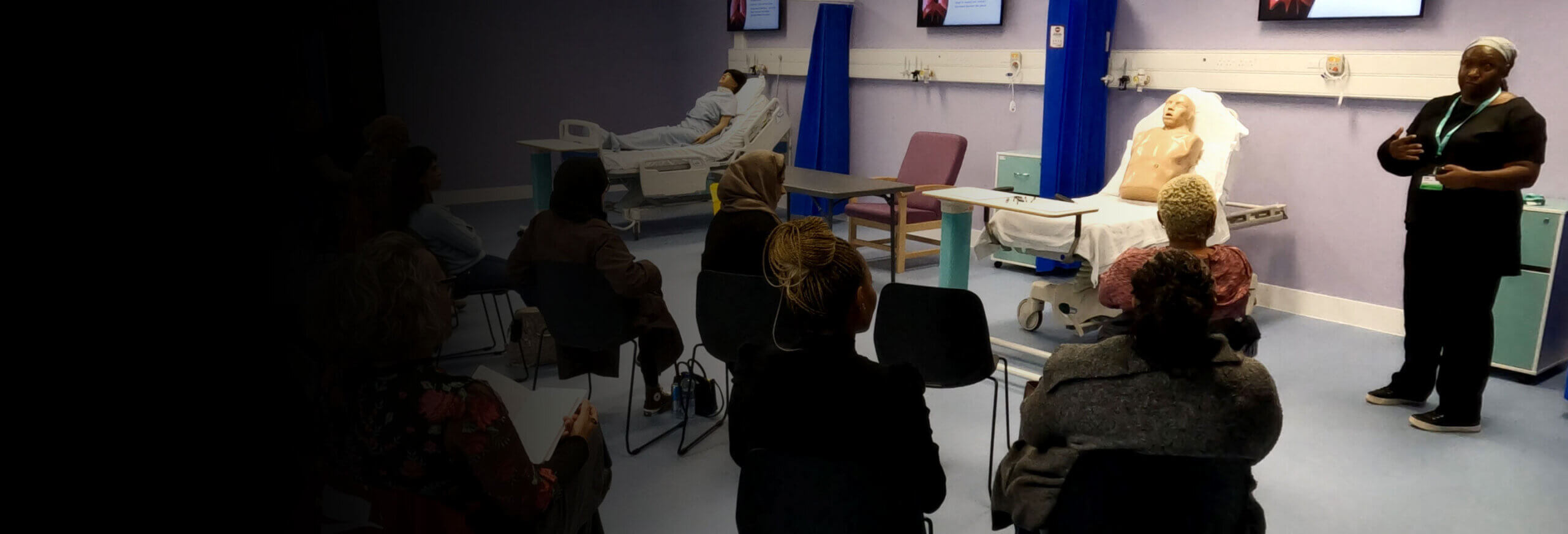 Professional training room with hospital beds and dummies.